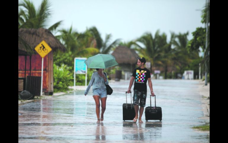 Prevención. Turistas dejan el hotel en Mahahual para resguardarse en uno de los refugios instalados. EL UNIVERSAL  /