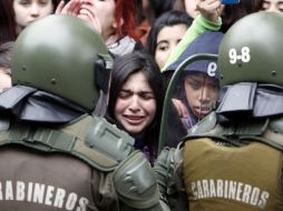 Una estudiante llora durante un enfrentamiento con la policía antidisturbios en una escuela de Santiago. REUTERS  /