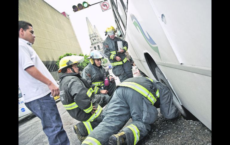 Bomberos revisan el camión que cayó en el hoyanco. Las primeras hipótesis apuntan a que hay agua fugándose de las redes subterráneas.  /