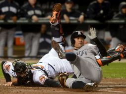 El jardinero izquierdo de Yanquis, Ichiro Suzuki evita ser ponchado por el receptor de Orioles, Matt Wieters. EFE  /