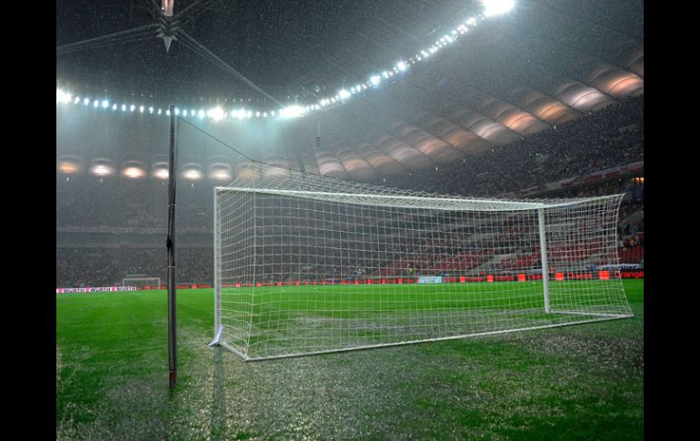 La lluvia dejo en malas condiciones el terreno enel estadio nacional de Varsovia. AFP  /