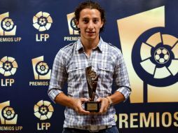 Guardado posa con el premio de la Liga de Fútbol Profesional (LFP) al mejor centrocampista de ataque. EFE  /