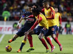 El jugador de América Jesús Molina (i) disputa el balón con Joel Adrián Huiqui (c) y Carlos Adrián Morales (d), de Monarcas. EFE  /