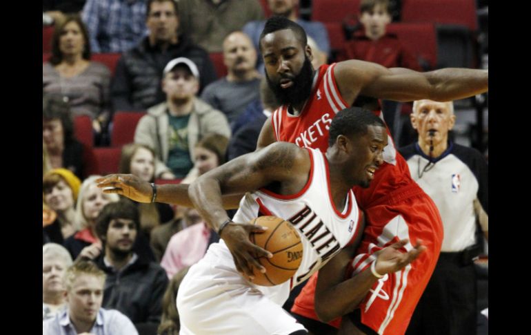 Wesley Matthews (i) pasa al lado de James Harden durante el partido. AP  /