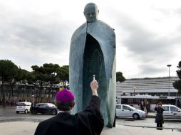 Un sacerdote bendice la estatua del Papa Juan Pablo II tras ser desvelada en Roma. EFE  /