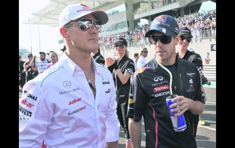 Dos generaciones. Michael Schumacher posa junto a Sebastian Vettel. AP  /