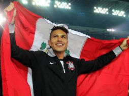 El peruano se paseó con una bandera de su país por el estadio. XINHUA  /