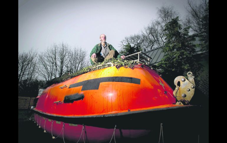 PRECAVIDO. Pieter van der Meer posa en el bote salvavidas de su jardín en Kootwijkerbroek, Holanda. EFE  /