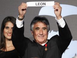 El ex futbolista, Percy Rojas, sostiene el nombre del club León durante la ceremonia de sorteo. AFP  /