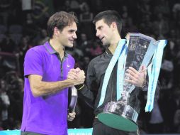 Con tu permiso. Novak Djokovic bromea con Roger Federer, tras la final ATP en Londres.  AP  /