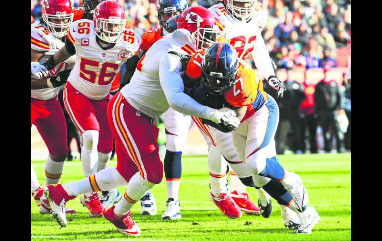 Poder puro. Knowshon Moreno (27) hace un esfuerzo para desplazar a Tamba Hali y anotar un touchdown. REUTERS  /