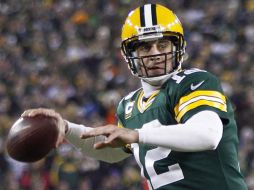 Aaron Rodgers tiene a los Empacadores en la siguiente fase de los playoffs. AP /