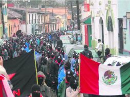 “Aquí estamos”. El pasado 21 de diciembre, los zapatistas marcharon silenciosamente hacia varias cabeceras municipales chiapanecas. AFP /