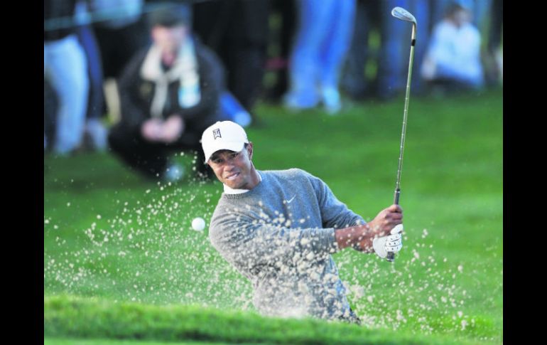 Como en los buenos tiempos. Woods está al frente con un total de 202 golpes, tras 54 hoyos. AP /