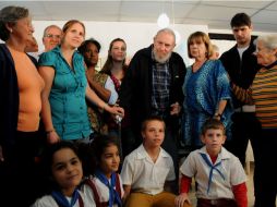 El líder cubano Fidel Castro posa con miembros del colegio electoral en que votó, en La Habana, Cuba. AP /