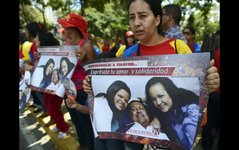 Simpatizantes de Chávez se reúnen frente al hospital para manifestarle su apoyo. AFP /