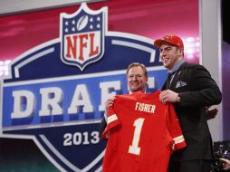 El comisionado Roger Goodell entrega su jerser a la primera selección de todo el Draft, Erick Fisher. AP /