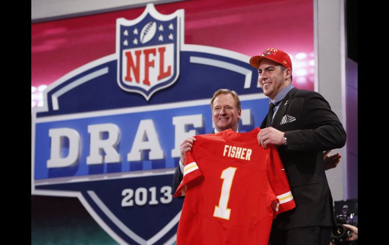 El comisionado Roger Goodell entrega su jerser a la primera selección de todo el Draft, Erick Fisher. AP /