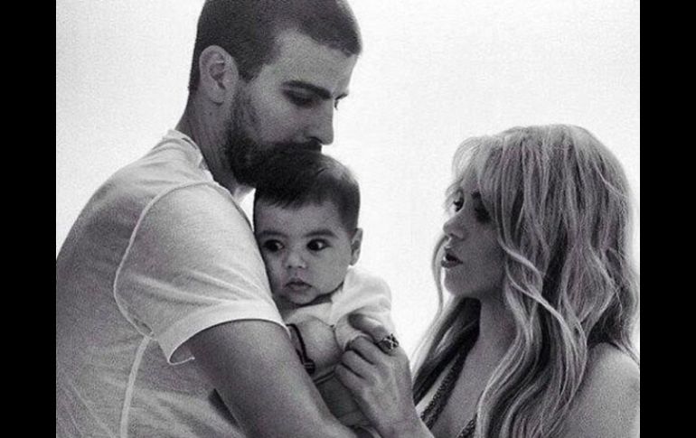 Piqué aparece en la imagen blanco y negro sosteniendo al pequeño Milan, mientras Shakira lo observa. ESPECIAL /