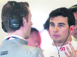 En sintonía. Checo Pérez dialoga con uno de los ingenieros previo al Gran Premio de Mónaco. ESPECIAL /