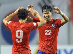 El cuadro coreano celebra su pase virtual a la copa del mundo en Brasil. AFP /