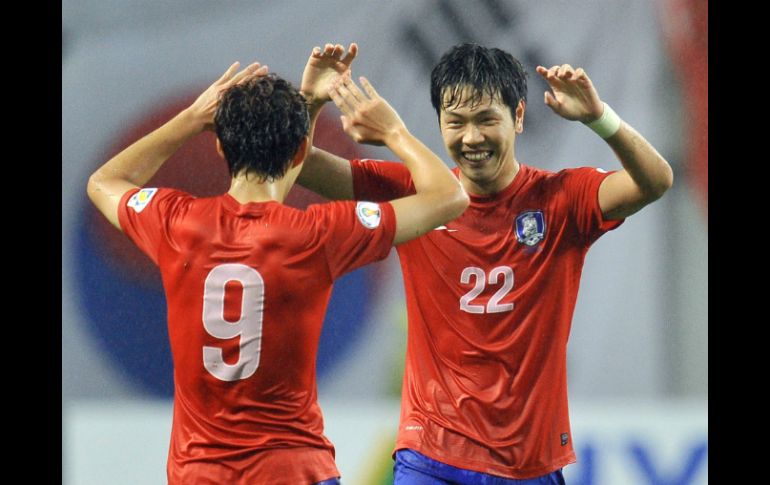 El cuadro coreano celebra su pase virtual a la copa del mundo en Brasil. AFP /