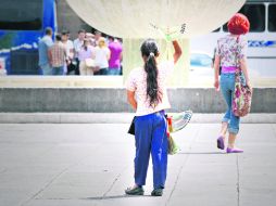 NIÑA VENDEDORA. Una menor de edad trabaja en el comercio informal vendiendo aves de juguete en la Plaza de la Liberación. EL INFORMADOR /