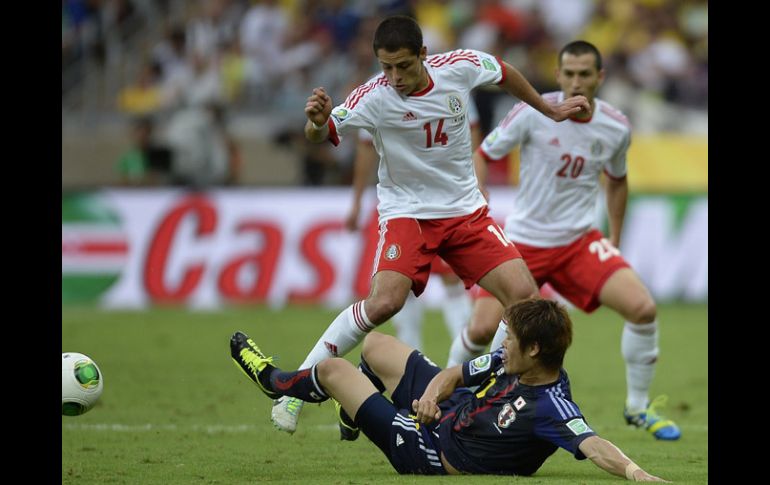 Javier Hernández lucha por la pelota ante Sakai durante el partido en Copa Confederaciones. AFP /