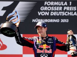 Sebastian Vettel levanta el trofeo que lo acredita como ganador del Gran Premio de Alemania. AFP /