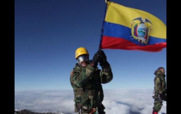 Rafael Correa ondea la bandera de Ecuador en la cima del volcán. TOMADA DE @FAlvaradoE  /