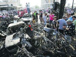 Decenas de personas se concentran en el lugar donde sucedió uno de los atentados con coche-bomba, en Trípoli,Líbano. AFP /