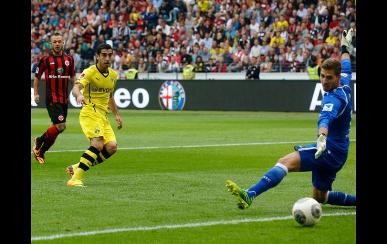 Henrikh Mkhitaryan define ante la salida del portero para anotar uno de sus dos goles del partido. AP /