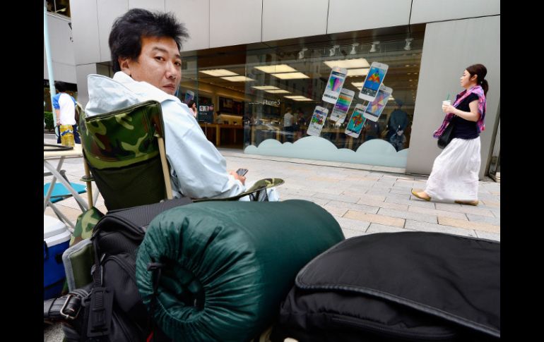 Un hombre espera fuera de una tienda de Apple en Tokio para poder adquirir el nuevo iPhone 5s. AFP /