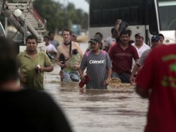 Peña Nieto corrobora que hay unidades habitacionales con inundaciones de más de un metro. AFP /