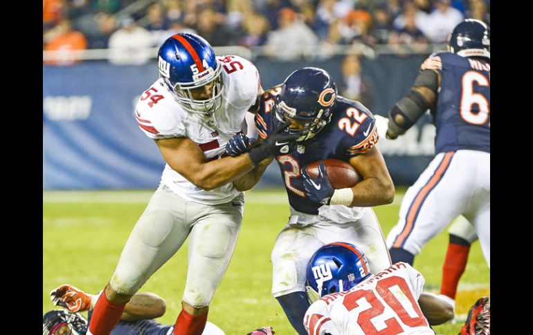 Matt Forte (c), de los Osos de Chicago, disputa un balón con los jugadores de los New York Giants Prince Amukamara (d) y Jon Beason (i) EFE /