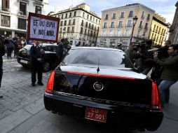 Un hombre sostiene una pancarta contra espionaje ante el coche del embajador de Estados Unidos en España. AFP /