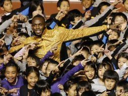 El multicampeón Usain Bolt se reúne con niños japoneses en Tokio. AP /