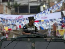 Un soldado vigila la entrada principal de un centro de votación en en un barrio de Tegucigalpa. EFE /