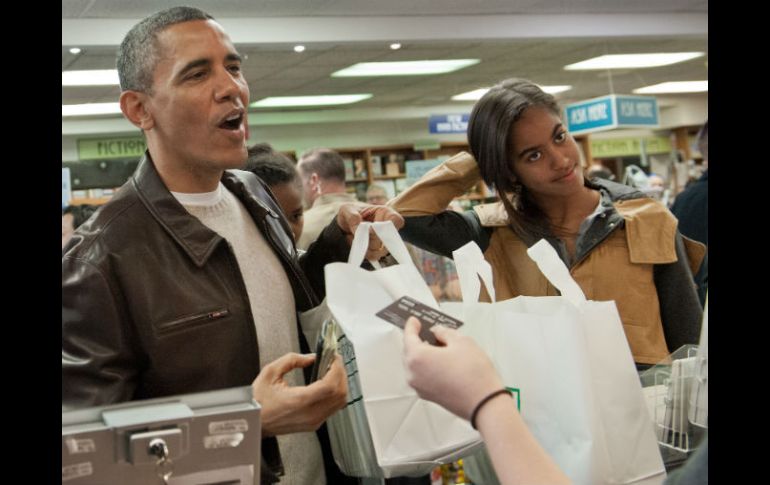 Barack Obama junto a sus hijas en la librería. AFP /