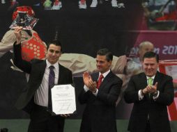 Recibe el premio Luis Rivera (i), medallista de bronce de salto de longitud en los Mundiales de Atletismo. NTX /