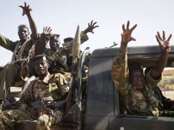 Miembros de la fuerza sursudanesa 'División León' saludan a fotógrafos que cubren los enfrentamientos. AFP /