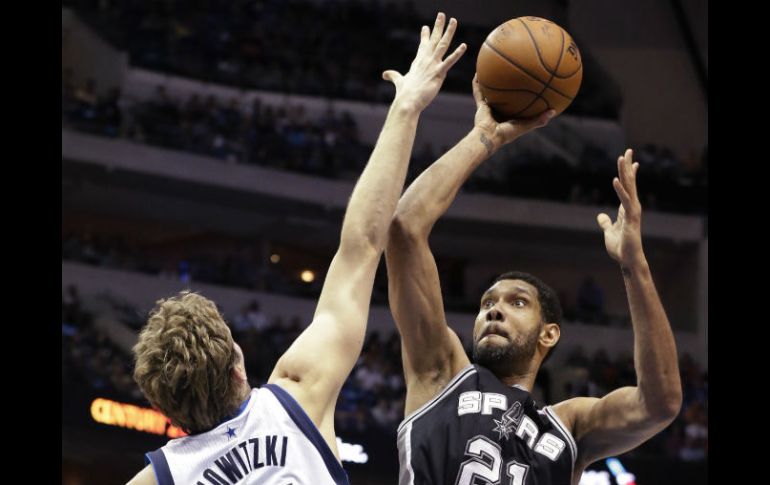 Tim Duncan dispara a la canasta ante la marcación de Nowitzki. AP /