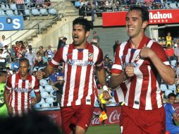 Diego Godín y Diego Costa celebran el triunfo de los Indios al vencer a los Azulones y avanzar en la Liga. EFE /