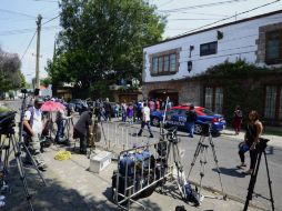 Periodistas permanecen fuera de la casa del escritor colombiano a la espera de más información. AFP /