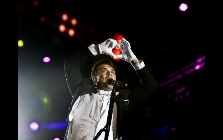 Robbie Williams, no defraudó a los alrededor de 60 mil seguidores que siguieron su concierto de apertura del Rock in Río. AFP /