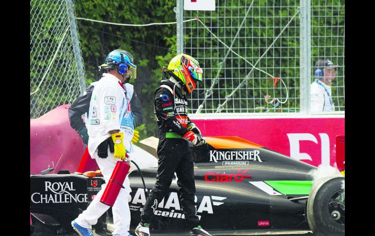 Sergio Pérez abandona el monoplaza, luego de haberse impactado contra el muro y abandonar la carrera. AP /