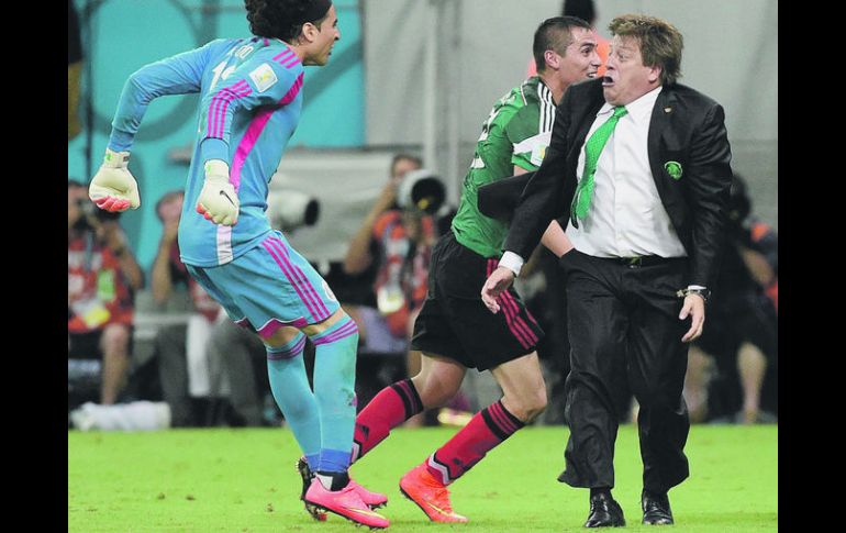 FESTEJO. El “Piojo” al momento de celebrar el segundo gol de México a Croacia. Guillermo Ochoa saltó encima de su DT. AFP /