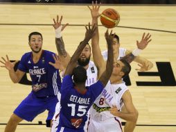 Francia y Serbia disputan el balón en partido de la fase de grupos. AFP /