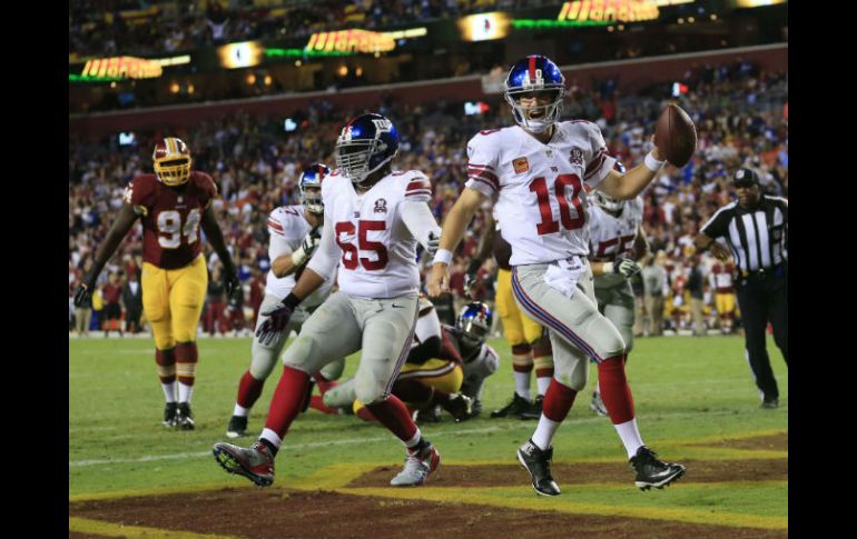 El mariscal de campo neoyorquino, Eli Manning, hace la última anotación del juego. AFP / R. Carr