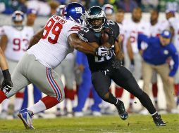 LeSean McCoy (25) de Filadelfia es bloqueado por Cullen Jenkins (99) de los Gigantes de Nueva York. AFP / R. Schultz